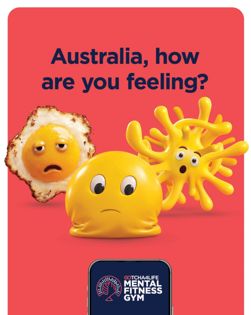 Red poster asks, “Australia, how are you feeling?” Three cartoon foods look sad or worried above a Mental Fitness Gym logo, conveying concern and support.